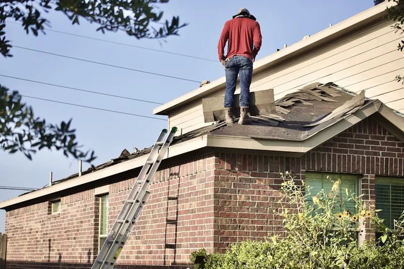 Professional roofer working on a residential roof in Outcalt